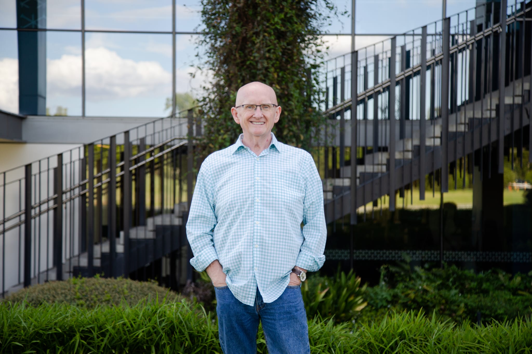 Richard Paterson standing outdoors in Melbourne smiling with hands in pockets