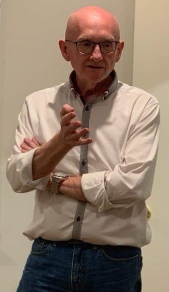 Richard Paterson talking expressively with hands while sharing a story